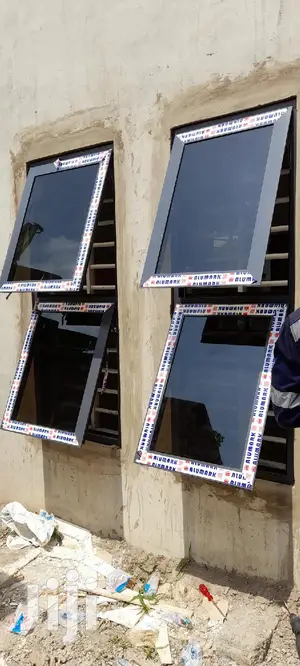 Gray Casement Windows With Dark Glass Well Installed
