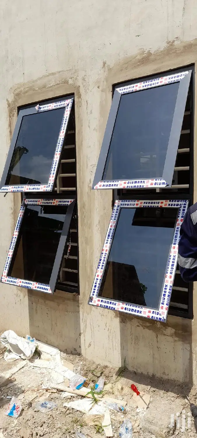 Gray Casement Windows With Dark Glass Well Installed
