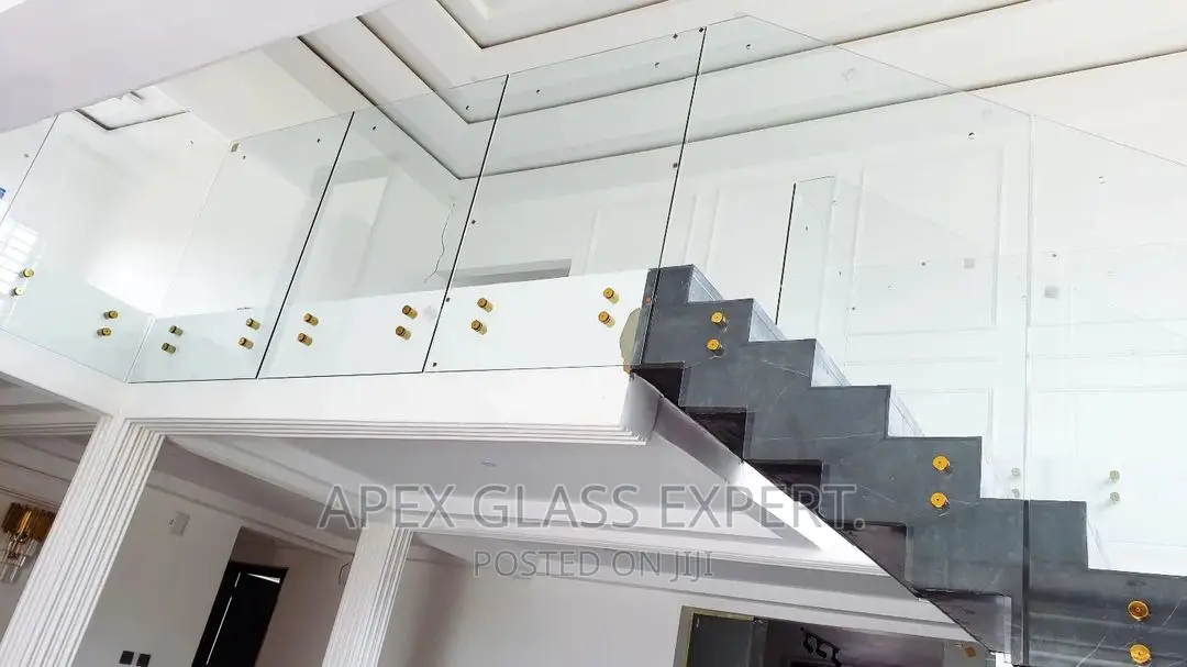 Staircase Glass With Gold Railing Support.