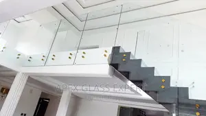Staircase Glass With Gold Railing Support.