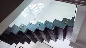 Staircase Glass With Gold Railing Support.