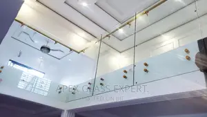 Staircase Glass With Gold Railing Support.
