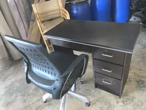 Brand New Table With Four Drawers and a Chair
