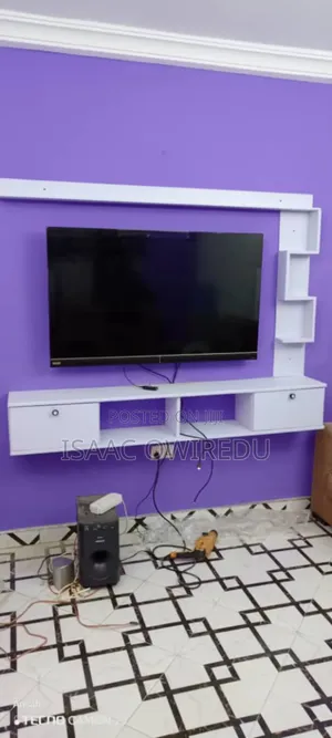 A Television Wall Mount With Doors and Shelves