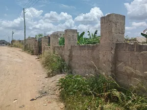 Uncompleted Building Building on Two Plots of Land