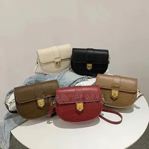 Compact Buckle-Flap Saddle Bag – Tan With Chain Accent