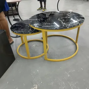 Modern Black Glass Nesting Coffee Tables With Gold Metal Frames.