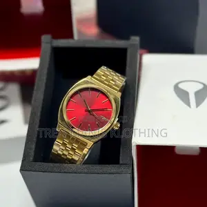 Nixon Gold Watch With Red Surface