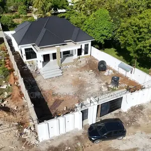A White Compound House Roofed With Classic Euro Roofing Tiles