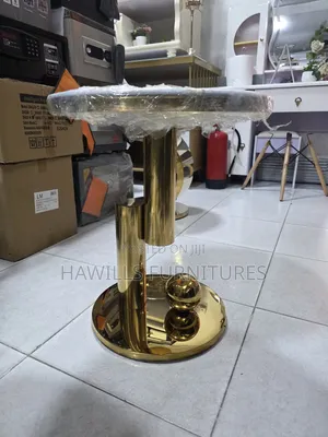 Gold-Finished Round Side Table With a Marble Top.