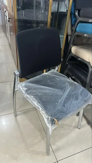 Black Padded Office Chair With a Chrome Metal Frame.