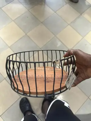 Black Metal Wire Fruit Basket Featuring a Round Wooden Base