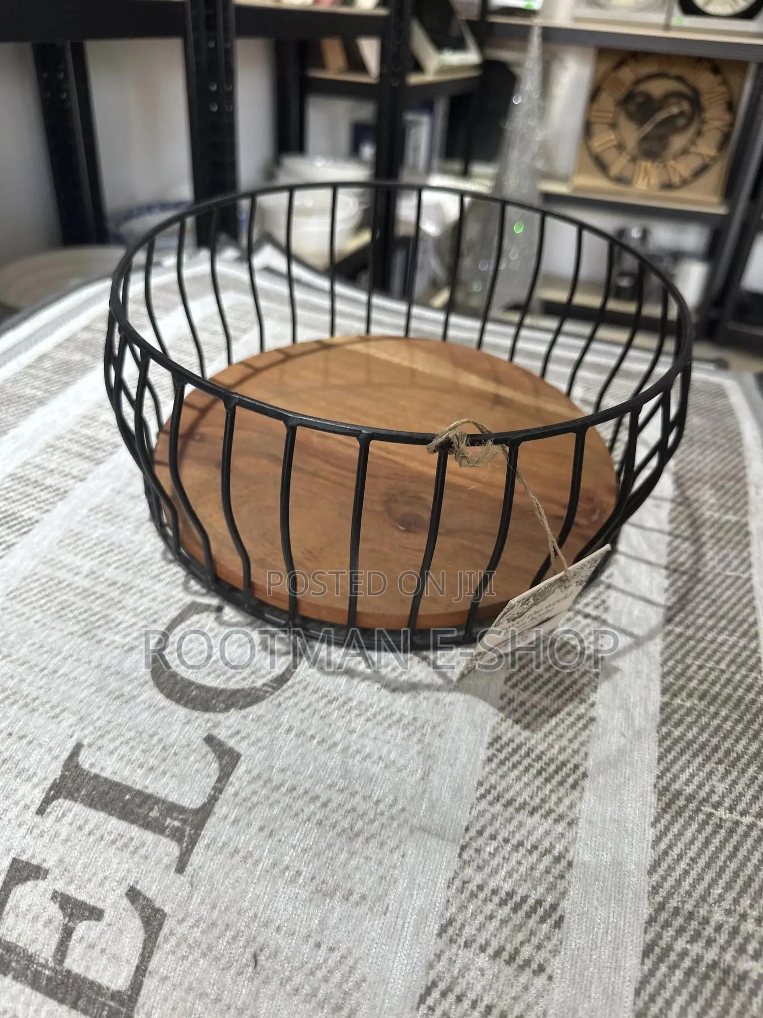Black Metal Wire Fruit Basket Featuring a Round Wooden Base