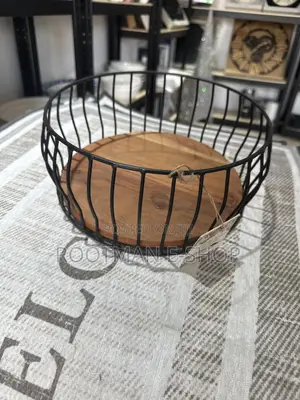 Black Metal Wire Fruit Basket Featuring a Round Wooden Base