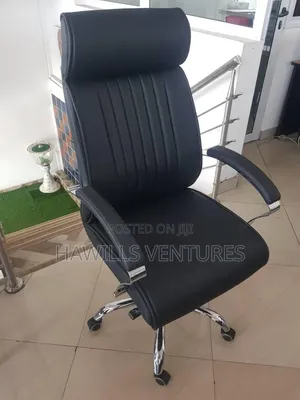 Black Leather High-Back Chair With Chrome Accent and Fixed Armrests.