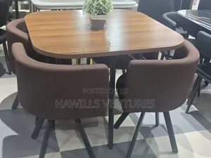 Modern Dining Set Features a Square Wooden Table With Dark Legs