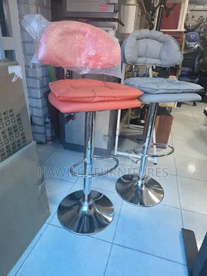 Adjustable Bar Stool Features a Double Padded Scalloped Backrest.