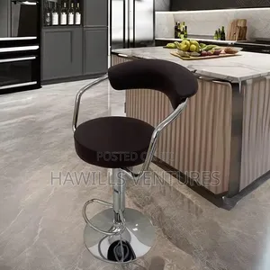 Swivel Bar Stool Featuring a Padded Seat and a Chrome Base.
