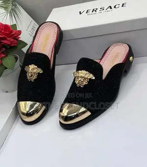 Versace Shoes Feature a Gold Toe Cap and a Medusa Emblem.